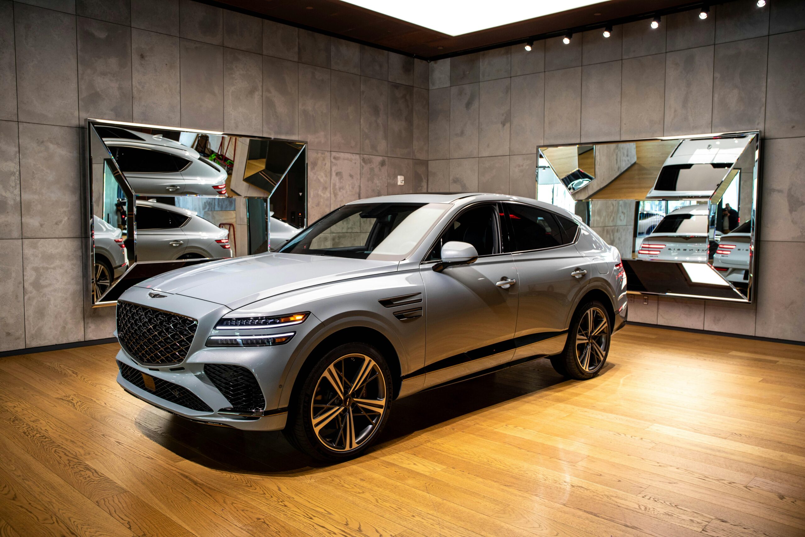 Sleek luxury SUV displayed in a modern indoor car showroom in New York City.